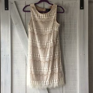 White and tan lace dress. Bridal occasion?